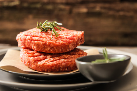 Raw Ground beef meat Burger steak cutlets on  wooden backgroundの写真素材