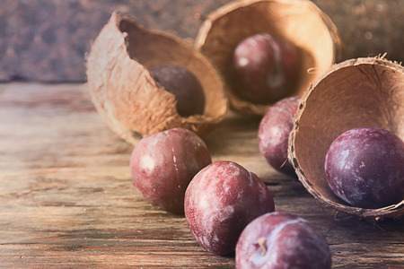 plum with blueberries ripe berries to the diet on a wooden background