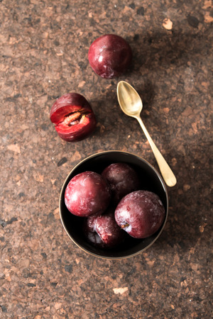 plum with blueberries ripe berries to the diet on a wooden backgroundの写真素材
