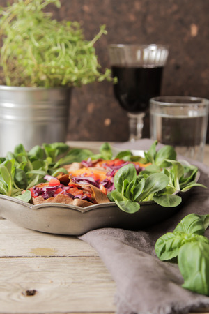 baked sweet potatoes in the oven with carrots and cabbage lettuceの写真素材