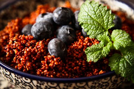 Quinoa blueberries and raspberries on a plateの写真素材