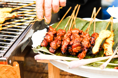 street food. skewers of meat on a skewer, fast food peopleの写真素材