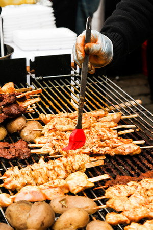 street food. skewers of meat on a skewer, fast food peopleの写真素材