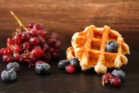 Belgian waffles with blueberries and grapes Breakfastの写真素材