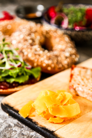 vegan bagel made at home with lettuce and sauce on a stone backgroundの写真素材