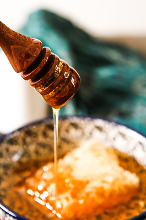 honey comb and blueberries on a stone backgroundの写真素材