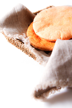 freshly baked pita bread on a wooden table close-up. rolling pin and flour in the background.の写真素材