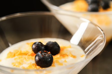 White yogurt with gold honey in a glass. Traditional greek dessert. Light healthy natural dietetic...