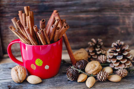 Christmas mood. cinnamon, walnuts and pine coneの写真素材