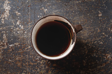 Iron mug with black tea. Dark backgroundの写真素材