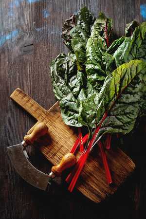 Swiss rainbow chard, vibrant vegetable. Flat lay, from above on a dark wooden backgroundの写真素材