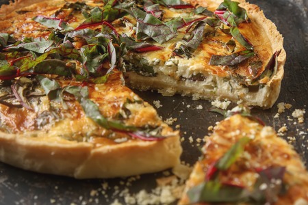 Traditional French cake. quiche with chard. Dark background. free space text. Top viewの写真素材
