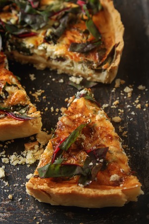 Traditional French cake. quiche with chard. Dark background. free space text. Top viewの写真素材