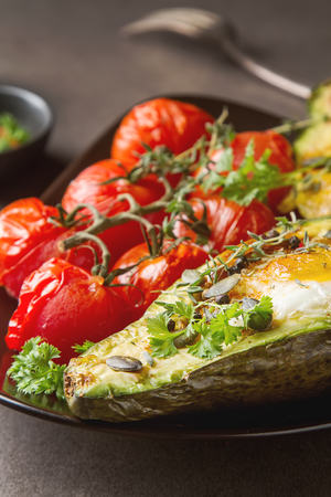 Homemade Organic Egg Baked in Avocado with Salt and Pepper. Gray backgroundの写真素材