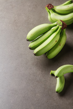 Bunch of ripe green bananas. Gray backgroundの写真素材