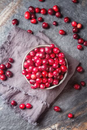 Red berries on a dark background. cranberries in a bowlの写真素材