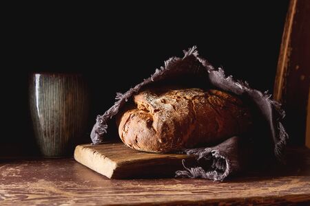 Fresh homemade French black bread. Dark background