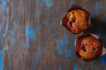 Blueberry muffins and fresh berries. Tasty dessert. Light breakfast. Dark backgroundの写真素材
