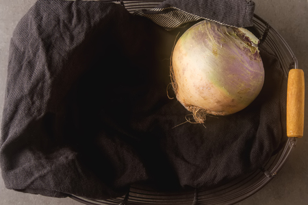 Ripe purple turnips with green leaves. Grey stone backgroundの写真素材