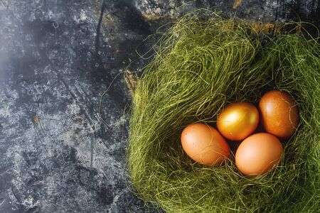 Multi-colored Easter egg. Golden eggs. Dark background. Spring holiday