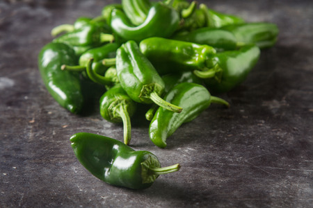 Green, fresh jalapeno peppers. Spicy Mexican food. Dark background
