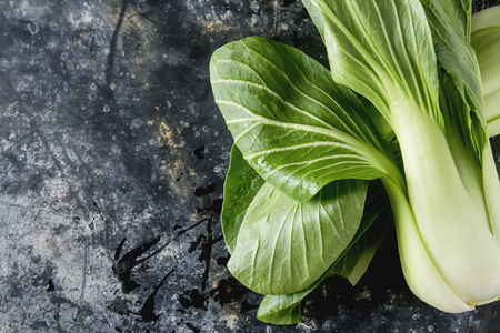 Overhead shot of Chinese cabbage, Bok Choy, on rustic background.の写真素材