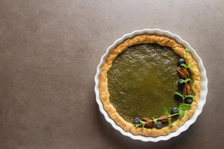 Green tea vegetarian pie match with nuts and mint. Dark background. Selective focusの写真素材