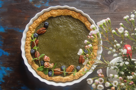 Green tea vegetarian pie match with nuts and mint. Dark background. Selective focusの写真素材