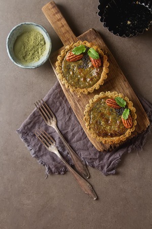 Green tea vegetarian pie match with nuts and mint. Dark background. Selective focusの写真素材