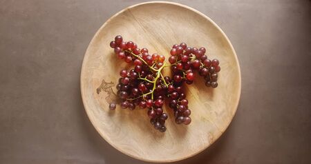 Fresh bunch of dark grapes. Autumn fruit. French and Italian culture. Dark backgroundの写真素材