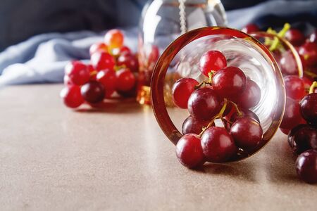 Fresh bunch of dark grapes. Autumn fruit. French and Italian culture. Dark backgroundの写真素材