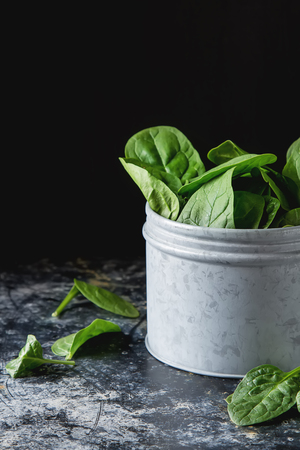 Washed fresh mini spinach on the old concrete table.の写真素材