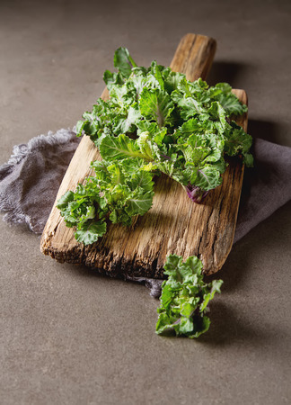 Fresh kale cabbage on a wooden board. Dark gray backgroundの写真素材