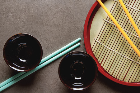 Chinese food. Two chopsticks for eating. Food sticks. Dark backgroundの写真素材