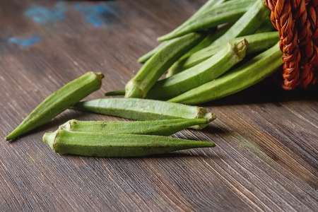 Lady Fingers or Okra over wooden table background. Space for textの写真素材