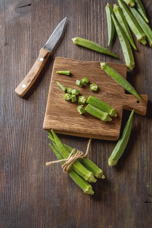 Lady Fingers or Okra over wooden table background. Space for textの写真素材