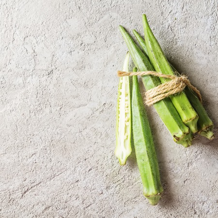 Lady Fingers or Okra over concrete table background. Space for textの写真素材