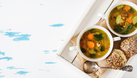 Winter detox soup of lentils in a ceramic bowl on a wooden background. Clean eating, weight loss, vegetarian food concept. Copy space. Top view.の写真素材