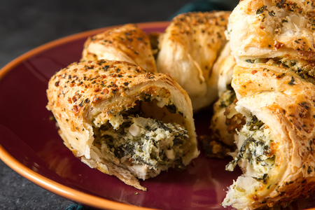 Greek pie spanakopita with spinach, cheese. Simple dark background. Healthy food. Lifestyleの写真素材