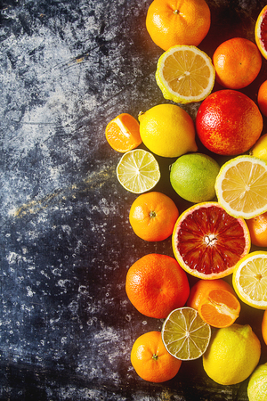 Citrus juice fruit and slices of orange, grapefruit, lemon, lime. Vitamin C. Black background.の写真素材