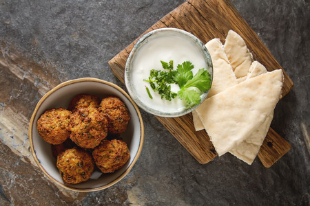 Middle Eastern traditional dishes. Falafel with sour cream. Vegetarian foodの写真素材