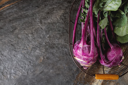 Ripe purple turnips with green leaves. Grey stone backgroundの写真素材