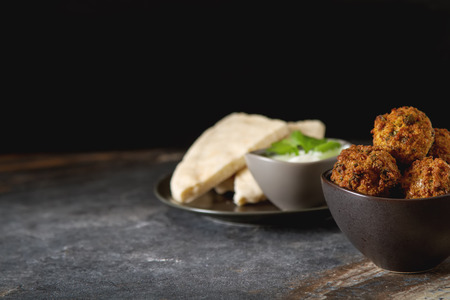 Middle Eastern traditional dishes. Falafel with sour cream. Vegetarian foodの写真素材