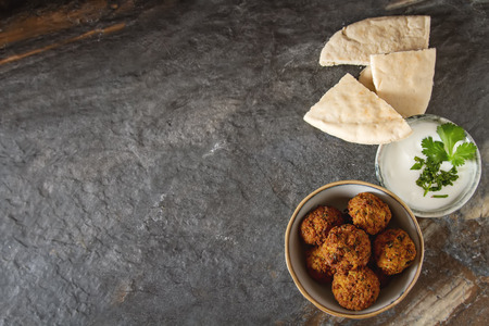 Middle Eastern traditional dishes. Falafel with sour cream. Vegetarian foodの写真素材