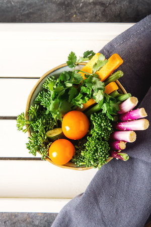 Dietary food. Green salad with melon, tomatoes, peppers, onions, beans, broccoli. Dark backgroundの写真素材