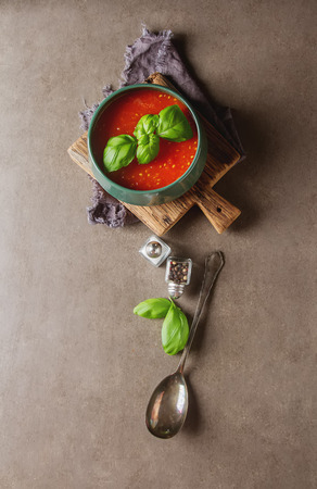 Traditional Italian tomato soup gazpacho with basil. Dark background. Space for textの写真素材