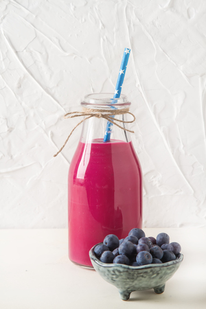 Fresh homemade smoothie with banana and berries. White backgroundの写真素材