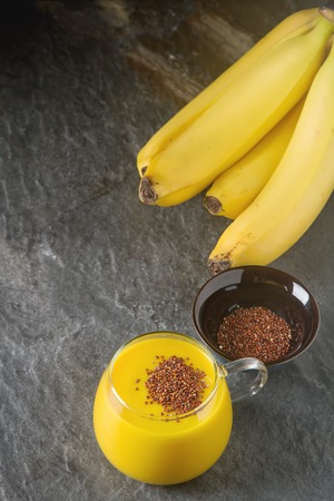 Fresh homemade smoothie with banana, quinoa. Dark backgroundの写真素材