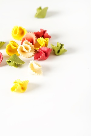 Multicolored Italian pasta. Delicious dinner for children. Pasta the boat. White backgroundの写真素材
