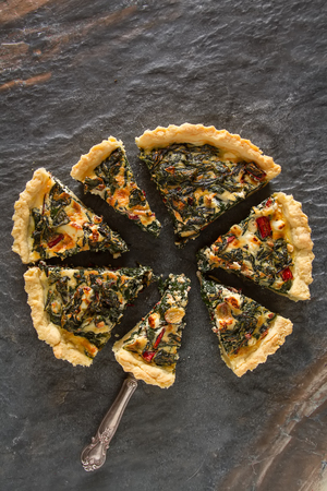 Homemade cheese Quiche egg for brunch with spinach and chard.の写真素材